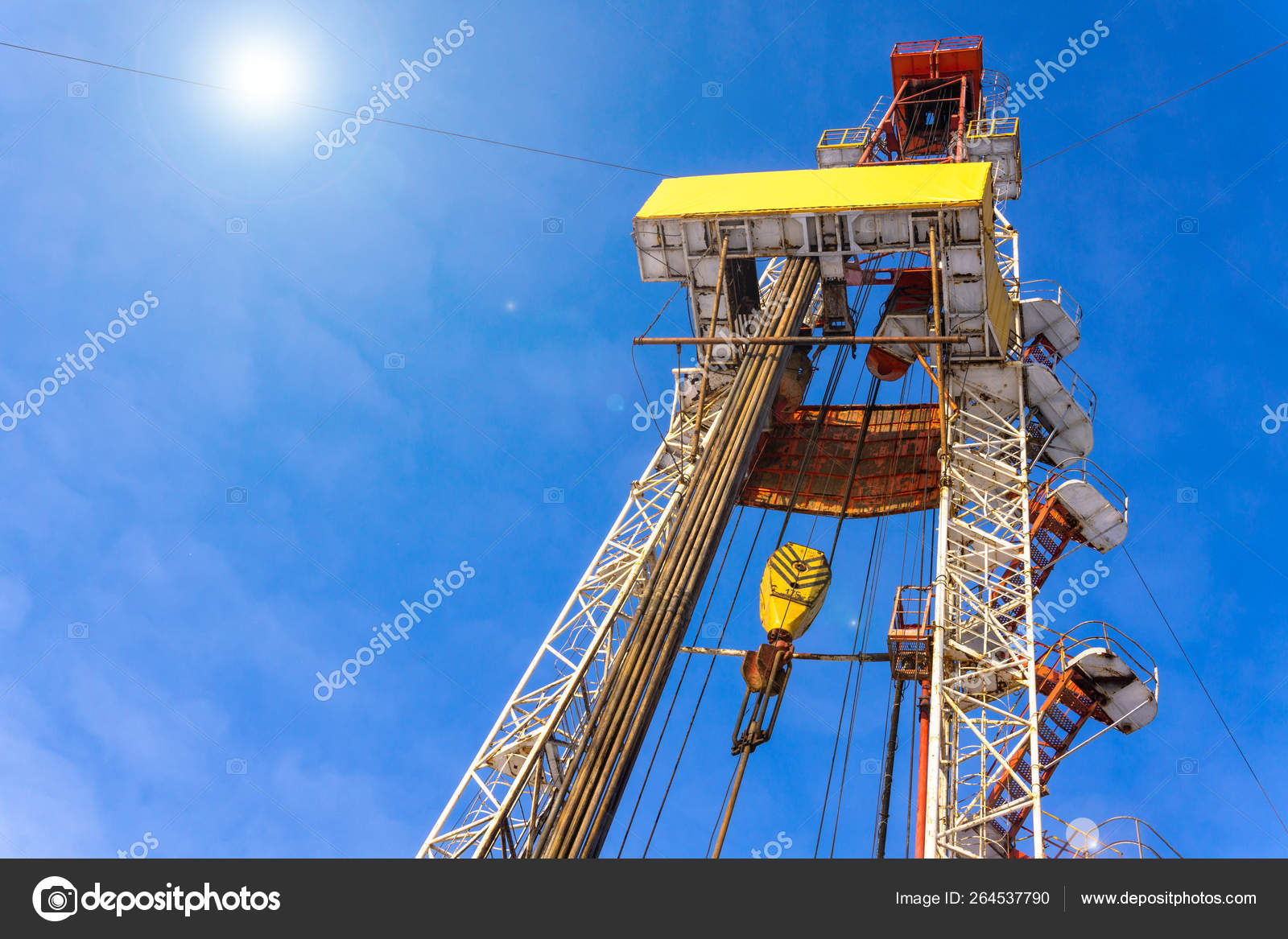 Oil and Gas Drilling Rig onshore dessert with dramatic cloudscape. Oil drilling rig operation on
