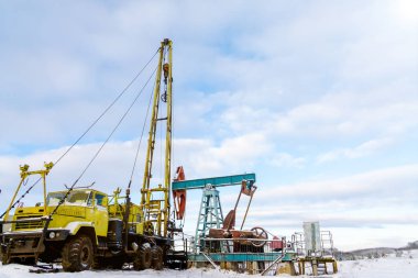 Madencilik ve taş ocağı. Dünya'nın bağırsaklarından yağ çıkarma için kurulumlar. Pumpjack bir yağ kuyusunda pistonlu pompa için yer üstü sürücü