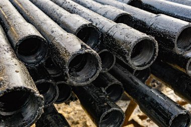 Petrol sondaj borusu. Paslı matkap boruları kuyu bölümünden delinmiş. Delik sondaj kulesi. Güverteye boru döşemek. Petrol ve benzin deposunun avlusundaki sondaj borularının görüntüsü.