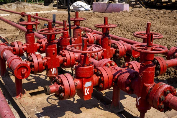 Oil and gas processing plant with pipe line valves. Oil pipeline valves in the oil and gas industry. Valve plug an oil pipeline in the field on a sunny summer day