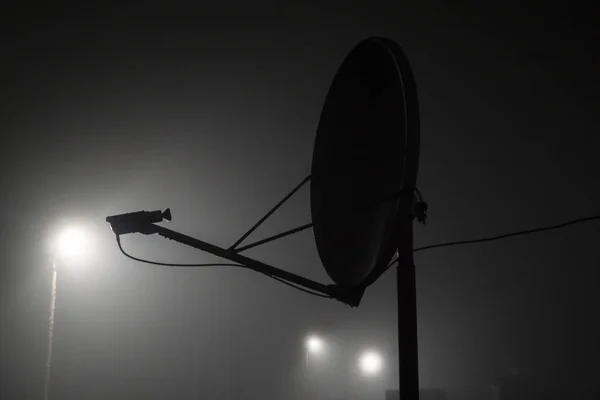 The silhouette of the satellite during the fog. Satellite transmission data