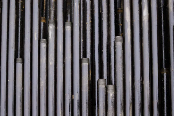 Drilling of oil and gas wells. Drill pipe inspection. Tubing for oil and gas listed on the pedestal out of the wells after washing and ready for inspection. Stack of casing laying on the deck — Stock Photo, Image