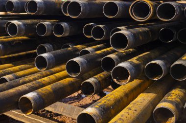 Petrol ve gaz kuyularının sondajı. Matkap borusu denetimi. Yıkandıktan ve kontrole hazır landıktan sonra kuyuların kaidesi üzerinde listelenen petrol ve gaz boruları. Güvertede döşeme kovan yığını