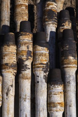 Petrol sondaj borusu. Paslı matkap boruları kuyu bölümünden delinmiş. Delik sondaj kulesi. Güverteye boru döşemek. Petrol ve benzin deposunun avlusundaki sondaj borularının görüntüsü