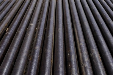 Petrol sondaj borusu. Paslı matkap boruları kuyu bölümünden delinmiş. Delik sondaj kulesi. Güverteye boru döşemek. Petrol ve benzin deposunun avlusundaki sondaj borularının görüntüsü