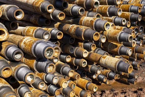 Forage de puits de pétrole et de gaz. Inspection des tuyaux de forage. Tubes pour le pétrole et le gaz énumérés sur le piédestal hors des puits après le lavage et prêt pour l'inspection. Empilement de carter posé sur le pont — Photo