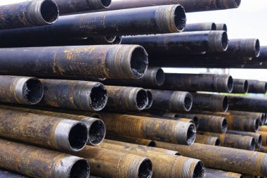 Petrol sondaj borusu. Paslı matkap boruları kuyu bölümünden delinmiş. Delik sondaj kulesi. Güverteye boru döşemek. Petrol ve benzin deposunun avlusundaki sondaj borularının görüntüsü.