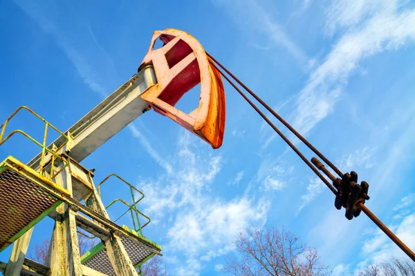 Oil and gas industry. Work of oil pump jack on a oil field in desert