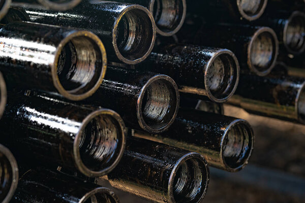 Drillpipe on Oil Rig Pipe Deck. Oil and gas industry. Work of oil pump jack on a oil field. 