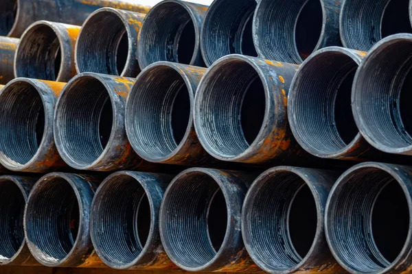 Steel Pipes bunch on the rack in warehouse. Iron pipes at shelf in warehouse.