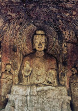 Luoyang, Hernan, China-December 25,2017 : A carved stone Buddha, carved from the rock, Longmen Grottoes and Caves, Luoyang, Henan Province, China clipart