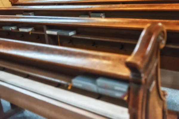 Empty Old church wooden bench chairs in the Cathedral Church worship hall