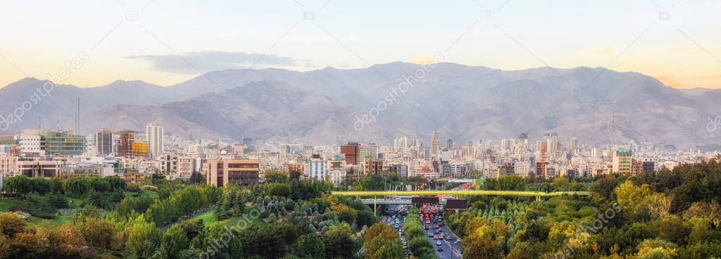 Skyline of Tehran, Iran with high rise buildings against mountains.