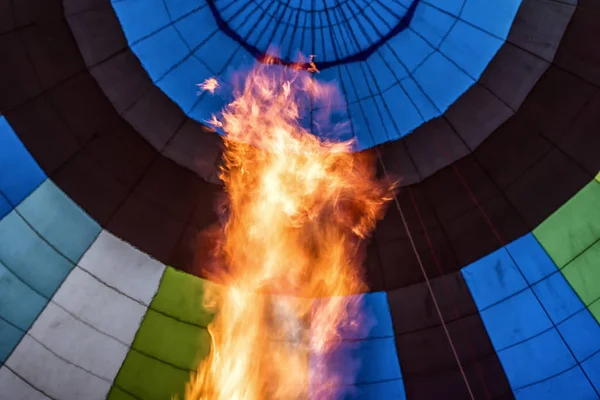 Balloon fire inflate fly air hot blue vertical interior.