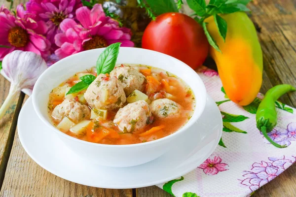 Tomato soup with chicken meatballs. Vegetable soup with chicken.