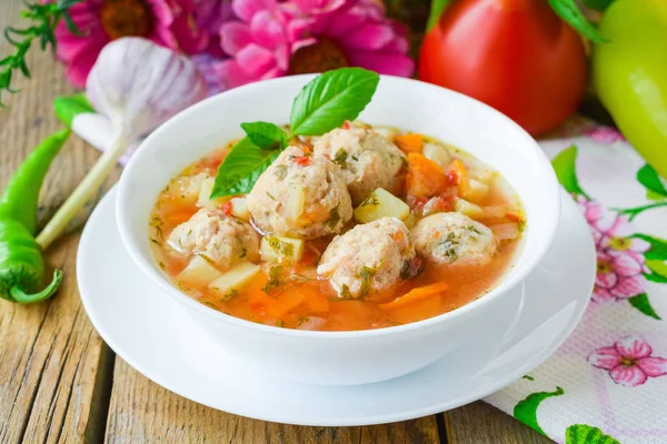 Tomato soup with chicken meatballs. Vegetable soup with chicken.