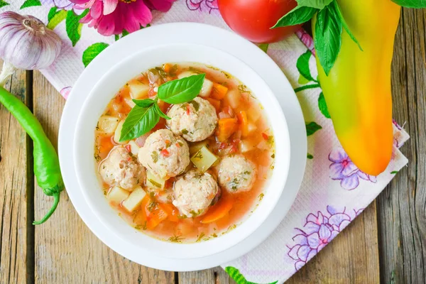 Tomato soup with chicken meatballs. Vegetable soup with chicken.