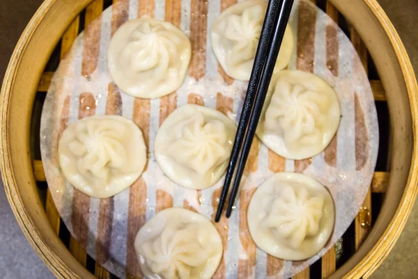 Traditional Chinese steamed dumplings in a bamboo steamer