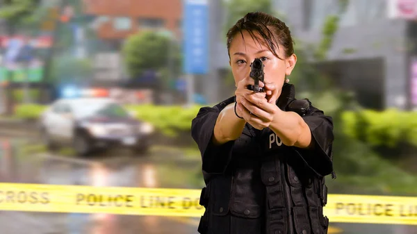 Asian American Woman Police Officer at Crime scene Pointing firearm