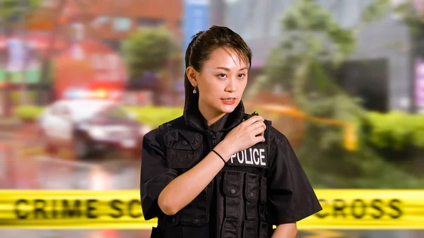 Asian American Woman Police Officer at Crime scene Calling for Backup on CB Radio