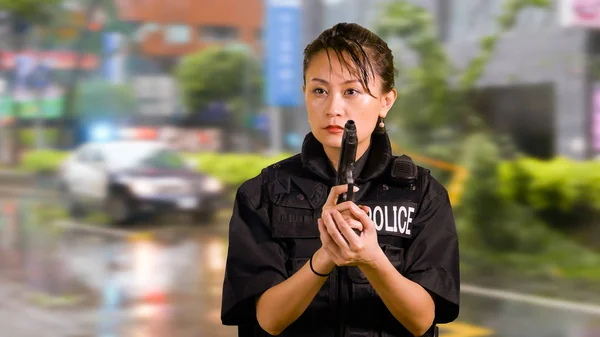 Asian American Woman Police Officer at Crime scene Holding Pistol