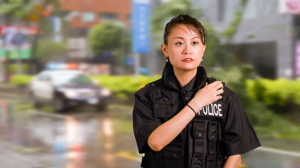 Asian American Woman Police Officer at Crime scene Talking on CB Radio