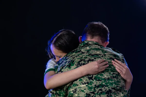 Soldier hugs daughter on departing or returning