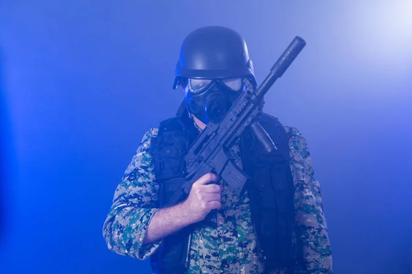 Soldado segurando rifle de assalto na névoa fumegante — Fotografia de Stock