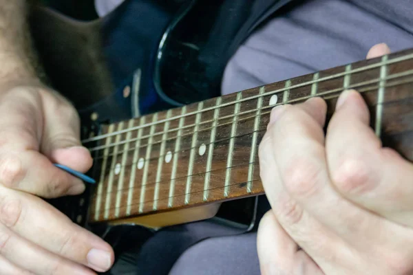 Close-up of man playing lead guitar solo — Stock Photo, Image