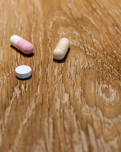 Capsules and pill on table — Stock Photo, Image