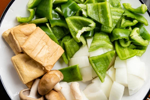 Zelené papriky, tofu, cibule a houby na talíři — Stock fotografie