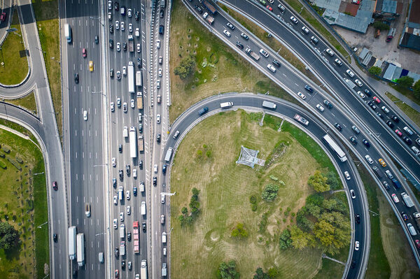 Traffic on highway with overpasses and exits. Big intersection. View from above. High quality photo. Top down view. Shot by drone.