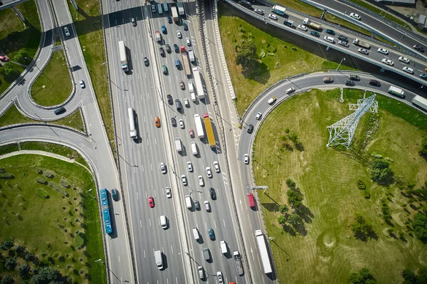 Traffic on highway with overpasses and exits. Big intersection. View from above. High quality photo. Top down view. Shot by drone.
