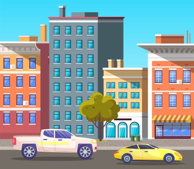 Şehir merkezindeki caddede araçlar evlerden geçiyor.