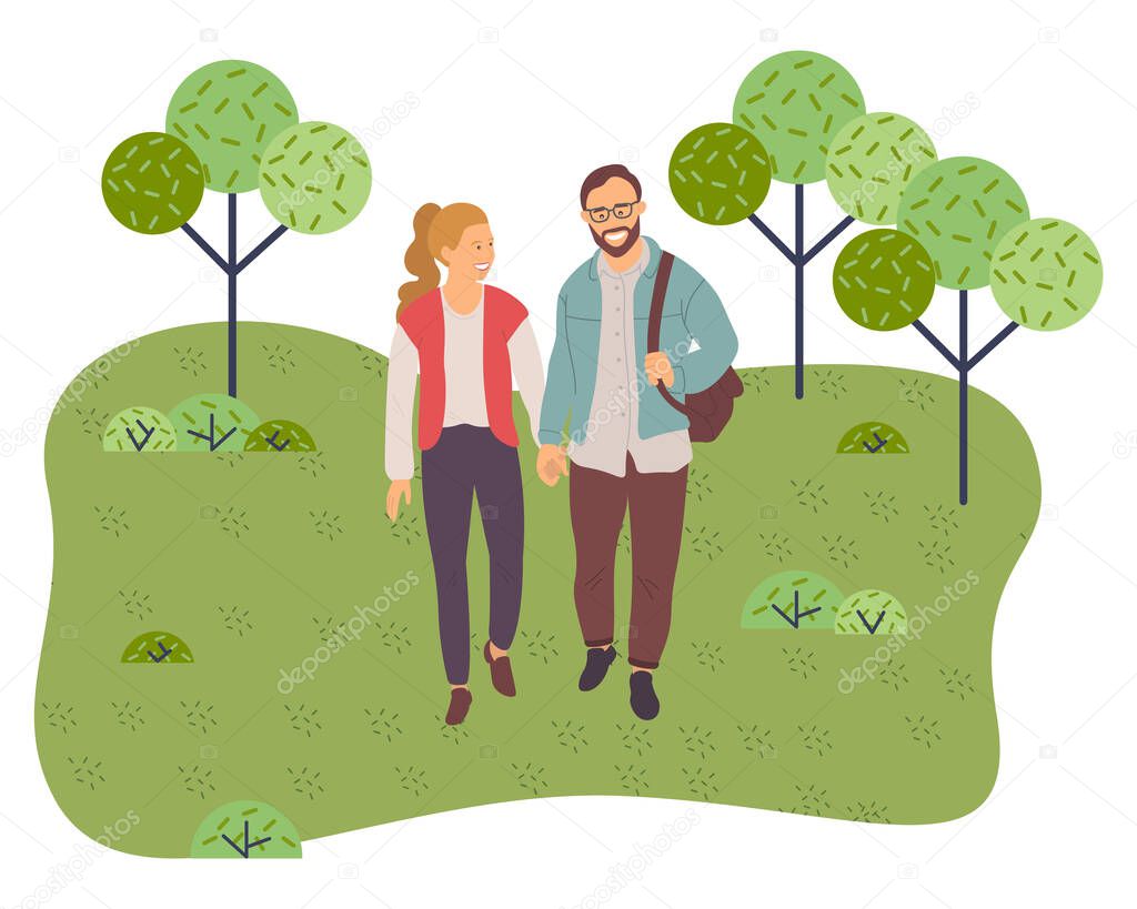 Couple walking in a park. Young man and woman holding hands walking in summer garden, romantic walk