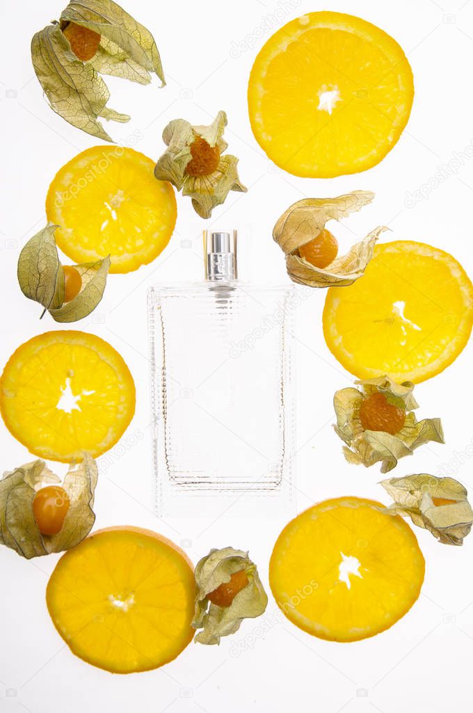 Citrus perfumes, refreshing fruity perfumes. Fruit orange background and perfume bottle