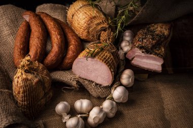 Füme domuz jambon, domuz pastırması ve sosis. Soğuk etlerin ev yapımı bir bileşimi.