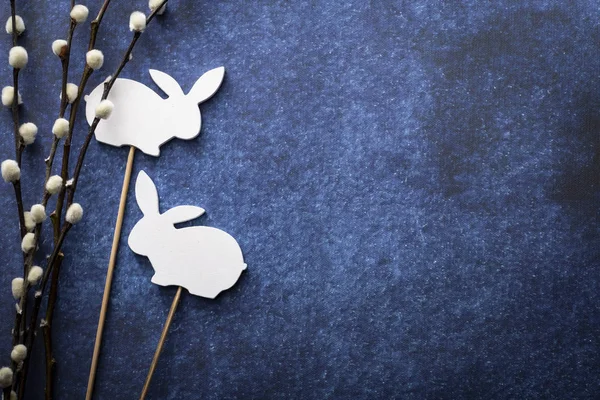 Easter background, Easter decorations, palms and bunnies on a dark blue background. — Stock Photo, Image