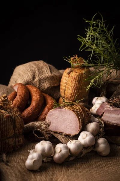 Viande fumée traditionnelle avec de la fumée en composition avec de l'ail frais et des herbes — Photo