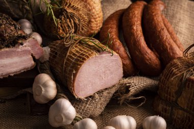 Füme domuz jambon, domuz pastırması ve sosis. Soğuk etlerin ev yapımı bir bileşimi.