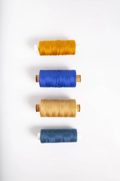 Bobbins of colorful cotton threads. Sewing accessories