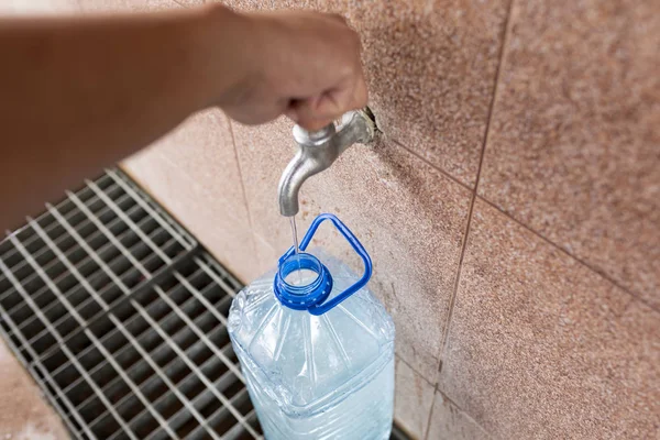 Ingesta de agua de ligoceno. Agua potable limpia. Verter agua en una botella de plástico . — Foto de Stock