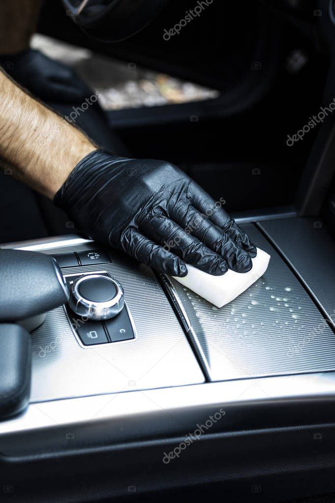 Vacuuming the car, cleaning the interior of the car with a microfiber cloth