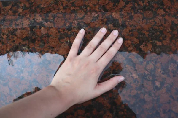 Hand in the water. Reflection. Horizontal photo