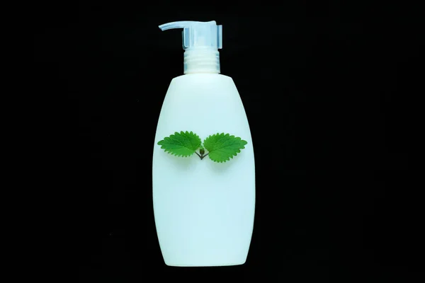 White cosmetic bottle for liquid soap on black background isolated. Container for a cream, shampoo, oil, gel,body balsam