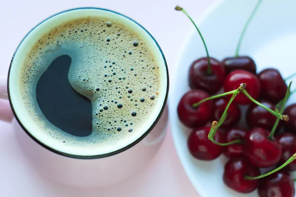 Coffee and cherries, minimalistic food concept. Top view, copy space.