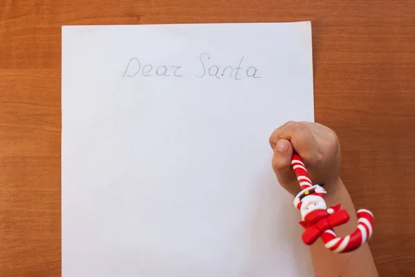 Małe dziecko pismo do Santa na Boże Narodzenie w domu na drewnianym stole w salonie. Kopiuj przestrzeń, flatlay. — Zdjęcie stockowe