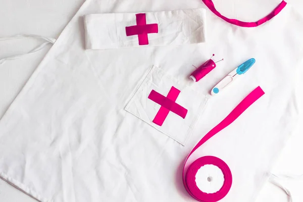 Doctor medical kit and lab coat for kids on a white background.