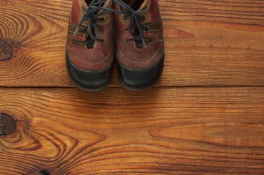 Deri çocuk botları ahşap bir arka plan görünümünde fotokopi alanı ile.