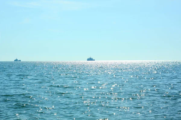 Reizen over zee. Prachtig uitzicht op de golven op een zonnige dag. Zonneschijn op het water. Schepen varen weg aan de horizon. — Stockfoto